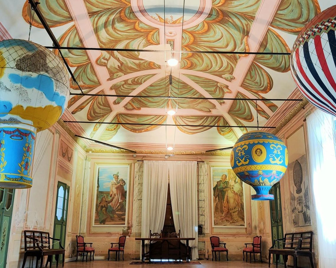 Sala con mongolfiere storiche appese al soffitto